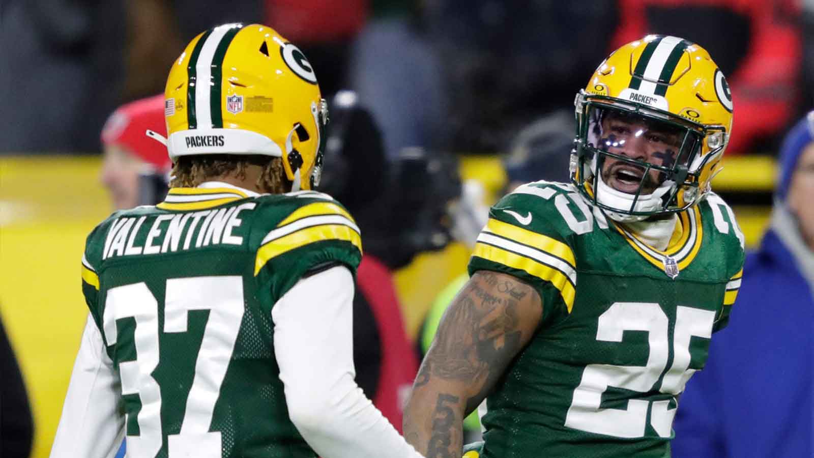 Green Bay Packers cornerback Keisean Nixon (25) celebrates his fourth quarter interception with cornerback Carrington Valentine (37)