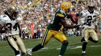 Green Bay Packers wide receiver Donald Driver catches a pass while being covered by New Orleans Saints Mike McKenzie (34) and Omar Stoutwire (23) for a 48-yard gain during the first quarter of their game against the New Orleans Saints at Lambeau Field in Green Bay on Thursday, September 8, 2011. The Packers won 42-34.