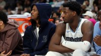 Grizzlies guard Ja Morant (left) and forward/center Jaren Jackson Jr. (right) looks on during the second quarter against the Brooklyn Nets at FedExForum with the Raptors logo in the background