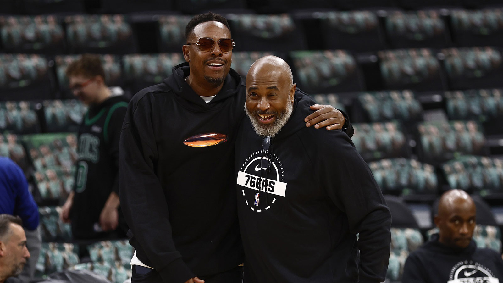 Celtics legend Paul Pierce has a laugh with Philadelphia 76ers assistant coach Rico Hines before the game between the Boston Celtics and the Philadelphia 76ers at TD Garden