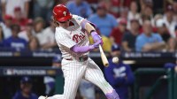 Philadelphia Phillies left fielder Harrison Bader (2) hits an RBI sacrifice fly against the Los Angeles Dodgers in the second inning during game one of the NLDS round for the 2025 MLB playoffs at Citizens Bank Park