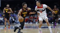 Hawks' Trae Young (11) drives vs. Wizards' Kyshawn George