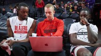 Portland Trail Blazers assistant coach Patrick St. Andrews instructs forward Jerami Grant (9), left, and guard Jrue Holiday (5) before a game against the Los Angeles Lakers at Moda Center.