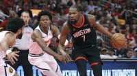 Houston Rockets forward Kevin Durant (7) dribbles the ball as Denver Nuggets guard Peyton Watson (8) defends during the second quarter at Toyota Center.
