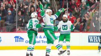 Carolina Hurricanes center Jordan Staal (11) is congratulated by defenseman Jalen Chatfield (5) and left wing Jordan Martinook (48) after scoring against the Utah Mammoth during the third period at Lenovo Center.