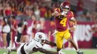 Southern California Trojans quarterback Husan Longstreet (4) carries the ball against Missouri State Bears cornerback Navonn Barrett (5) in the second half at United Airlines Field at Los Angeles Memorial Coliseum.