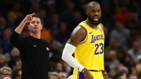Los Angeles Lakers forward LeBron James (23) and head coach JJ Redick against the Phoenix Suns in the first half at Mortgage Matchup Center.