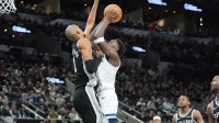 Minnesota Timberwolves guard Anthony Edwards (5) shoots against San Antonio Spurs forward Victor Wembanyama (1) in the first half at Frost Bank Center.