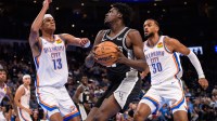 San Antonio Spurs center Charles Bediako (27) goes to the basket while defended by Oklahoma City Thunder forward Ousmane Dieng (13) during the second half at Paycom Center.
