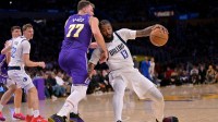Los Angeles Lakers guard Luka Doncic (77) fouls Dallas Mavericks forward Naji Marshall (13) in the second half at Crypto.com Arena.