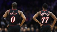 Philadelphia 76ers guard Tyrese Maxey (0) and guard Vj Edgecombe (77) look on during a break in the second quarter against the New York Knicks at Xfinity Mobile Arena.