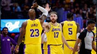 Los Angeles Lakers forward Drew Timme (17) reacts with forward LeBron James (23) in the second quarter against the Denver Nuggets at Ball Arena.