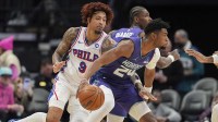 Charlotte Hornets forward Brandon Miller (24) handles the ball defended by Philadelphia 76ers forward/guard Kelly Oubre Jr. (9) during the first quarter at Spectrum Center.