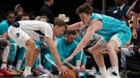 Dallas Mavericks forward Cooper Flagg (32) and Charlotte Hornets guard/forward Kon Knueppel (7) battle for the loose ball in the first half of a game at American Airlines Center.