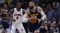 Denver Nuggets center Jonas Valanciunas (17) passes the ball away from Detroit Pistons center Jalen Duren (0) in the second half at Ball Arena.