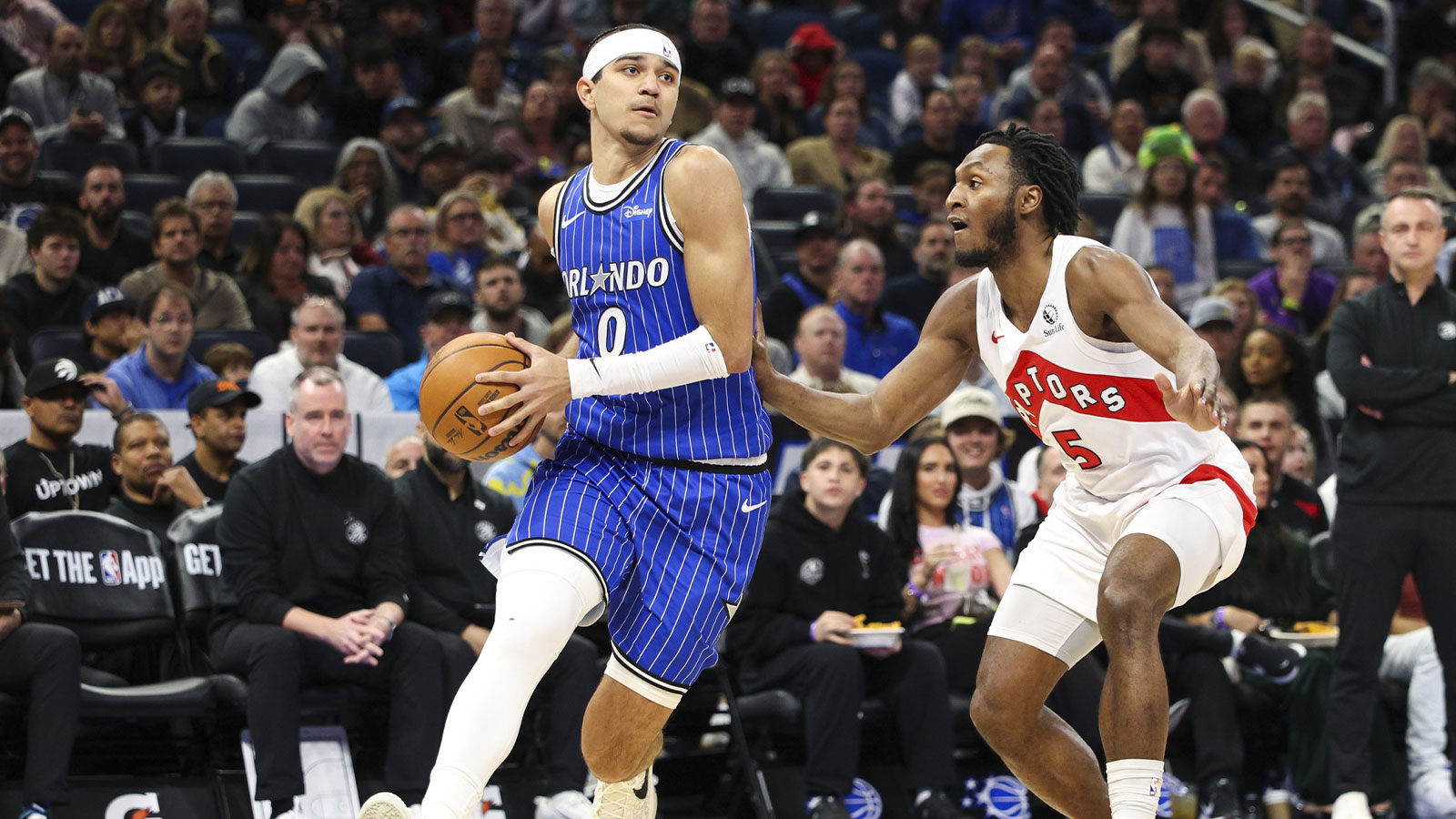 Orlando Magic guard Anthony Black (0) drives to the basket past Toronto Raptors guard Immanuel Quickley (5) in the first quarter at Kia Center.