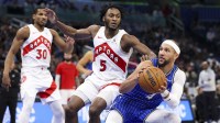 Orlando Magic guard Jalen Suggs (4) looks to shoot the ball defended by Toronto Raptors guard Immanuel Quickley (5) in the second quarter at Kia Center.