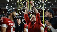 Indiana Hoosiers head coach Curt Cignetti hoists the National Championship trophy in the air after the College Football Playoff National Championship game at Hard Rock Stadium.