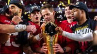 Indiana Head Coach Curt Cignetti prepares to lift the trophy on the podium after the College Football Playoff National Championship college football game at Hard Rock Stadium in Miami Gardens on Monday, Jan. 19, 2026.