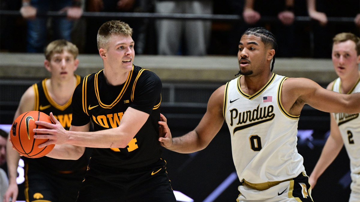 Iowa Hawkeyes guard Bennett Stirtz (14) looks for an open teammate around Purdue Boilermakers guard C.J Cox (0) during the second half at Mackey Arena.