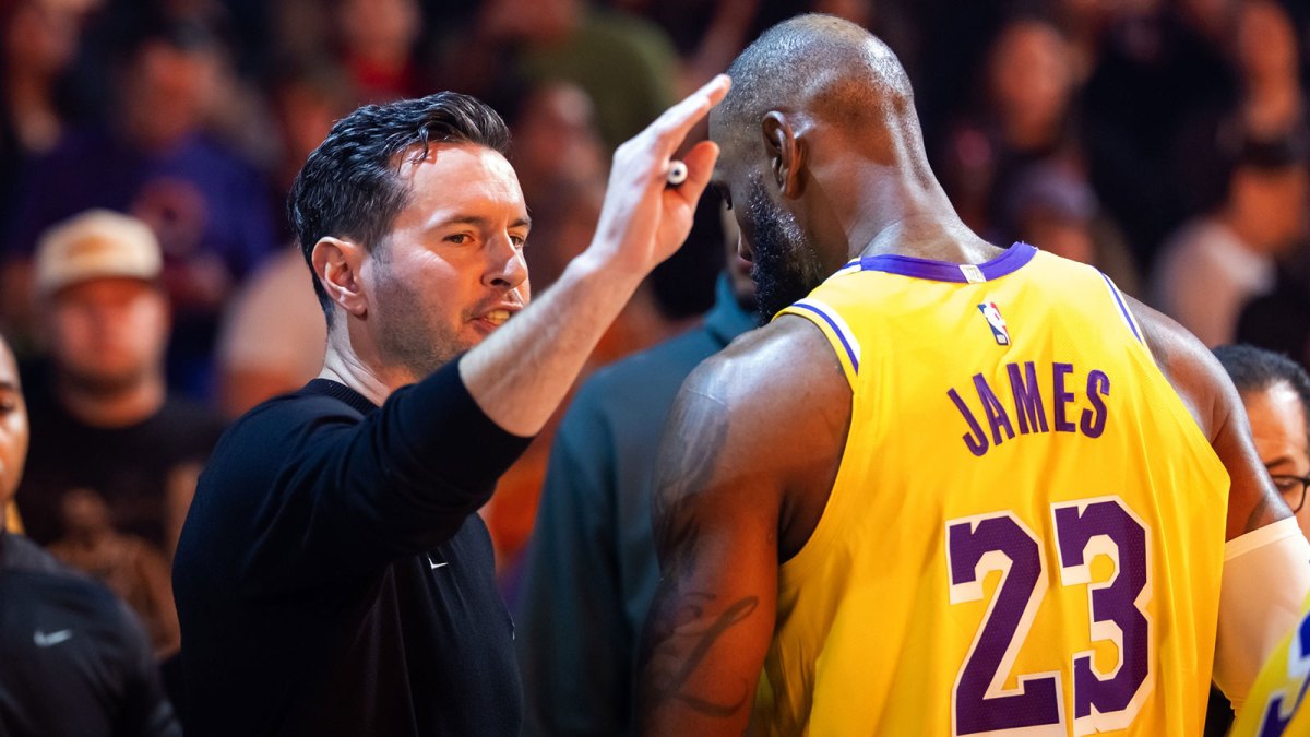 Lakers forward LeBron James (23) and head coach JJ Redick interact