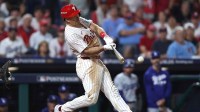 Philadelphia Phillies catcher J.T. Realmuto (10) reaches first base on an error against the Los Angeles Dodgers in the seventh inning during game one of the NLDS round for the 2025 MLB playoffs at Citizens Bank Park.
