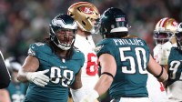 Philadelphia Eagles defensive tackle Jalen Carter (98) celebrates after a sack against the San Francisco 49ers with linebacker Jaelan Phillips (50) during the second quarter in an NFC Wild Card Round game at Lincoln Financial Field.