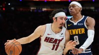 Miami Heat forward Jaime Jaquez Jr. (11) drives to the basket against Denver Nuggets guard Peyton Watson (8) during the fourth quarter at Kaseya Center.