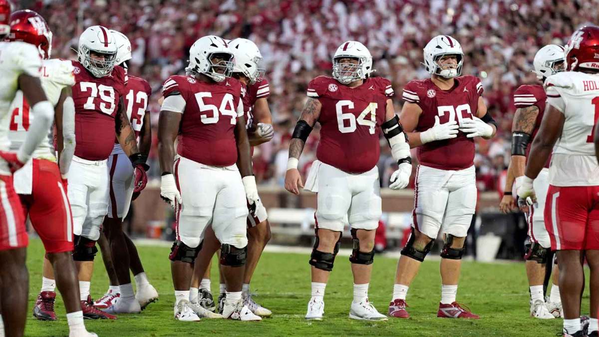 Oklahoma Sooners offensive lineman Jake Taylor (79), offensive lineman Febechi Nwaiwu (54), offensive lineman Joshua Bates (64) and offensive lineman Jacob Sexton (76) walk to the line during a college football game between the University of Oklahoma Sooners (OU) and the Houston Cougars.