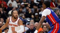 New York Knicks guard Jalen Brunson (11) idk Detroit Pistons guard Ausar Thompson (9) in the first half at Little Caesars Arena.
