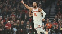 New York Knicks guard Jalen Brunson (11) reacts after scoring a three-point shot against the Portland Trail Blazers during the first half at Moda Center.