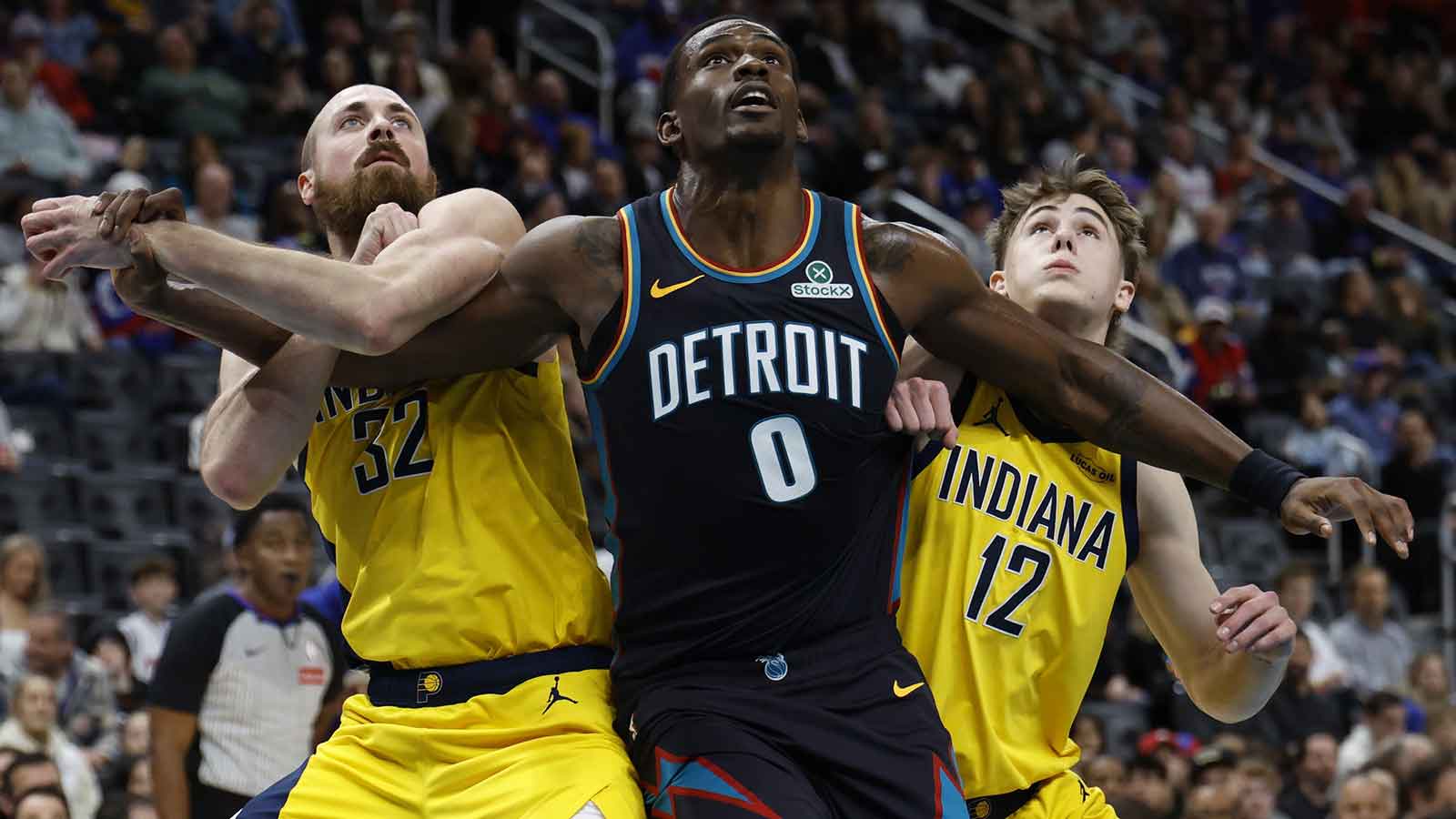 Indiana Pacers center Jay Huff (32), Detroit Pistons center Jalen Duren (0) and guard Johnny Furphy (12) look for the rebound at Little Caesars Arena.