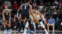 Atlanta Hawks forward Jalen Johnson (1) looks for a play against Milwaukee Bucks forward Giannis Antetokounmpo (34) during the fourth quarter at State Farm Arena.
