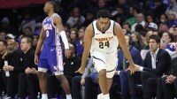Denver Nuggets guard Jalen Pickett (24) reacts to his three pointer in front of Philadelphia 76ers guard Tyrese Maxey (0) during the second quarter at Xfinity Mobile Arena.