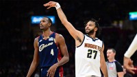 Denver Nuggets guard Jamal Murray (27) watches his shot after shooting a three point basket over Cleveland Cavaliers center Evan Mobley (4) during the second half at Rocket Arena.