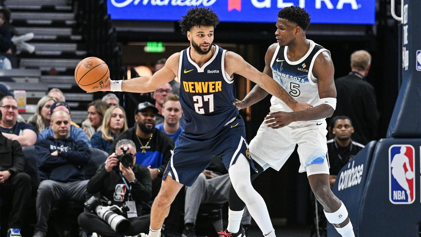 Denver Nuggets guard Jamal Murray (27) is defended by Minnesota Timberwolves guard Anthony Edwards (5) during the third quarter at Target Center. 