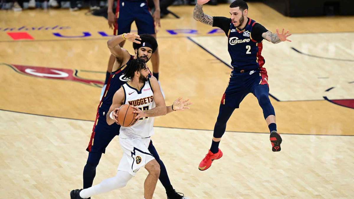 Denver Nuggets guard Jamal Murray (27) looks to pass while being pressured by Cleveland Cavaliers center Jarrett Allen (31) and guard Lonzo Ball (2) during the second half at Rocket Arena.