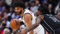 Brooklyn Nets guard Terance Mann (14) defends Denver Nuggets guard Jamal Murray (27) in the first quarter at Ball Arena.