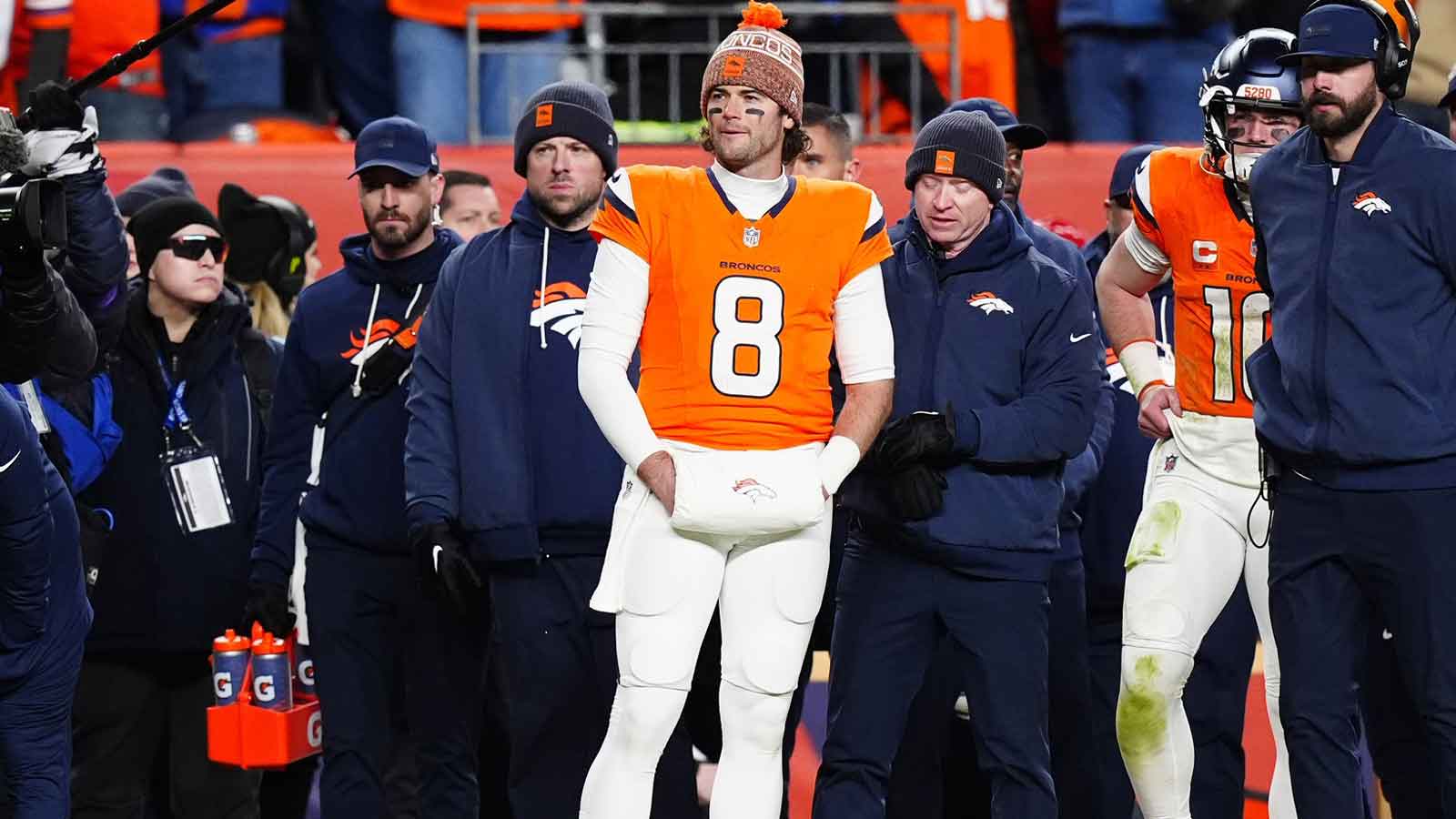 Denver Broncos quarterback Jarrett Stidham (8) stands next to quarterback Bo Nix (10)) during overtime of an AFC Divisional Round playoff game against the Buffalo Bills at Empower Field at Mile High.
