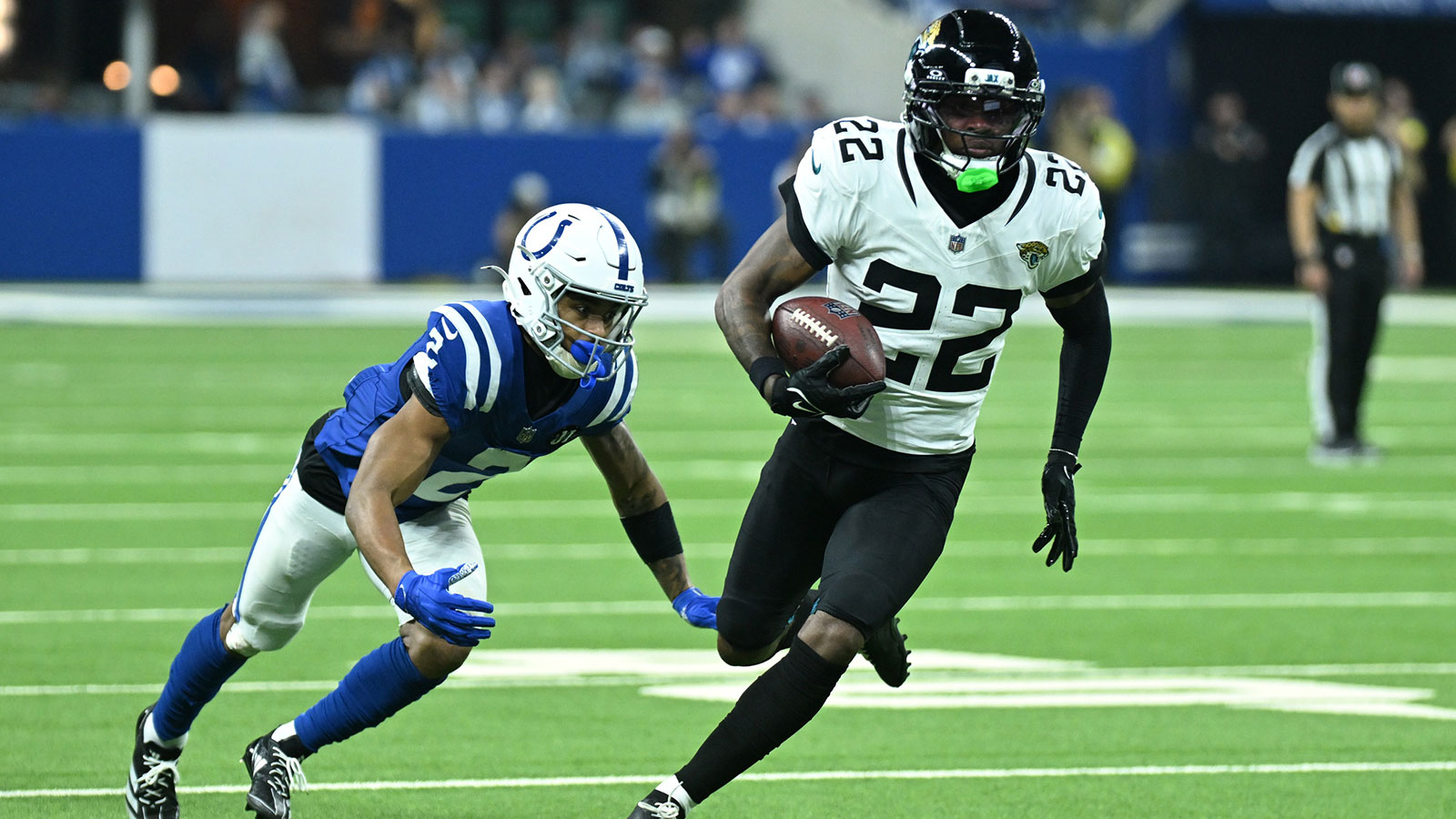 Jacksonville Jaguars cornerback Jarrian Jones (22) runs against Indianapolis Colts wide receiver Josh Downs (2) during the second half at Lucas Oil Stadium.