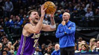 Lakers Luka Doncic shooting a basketball on left Mavericks Jason Kidd on right.