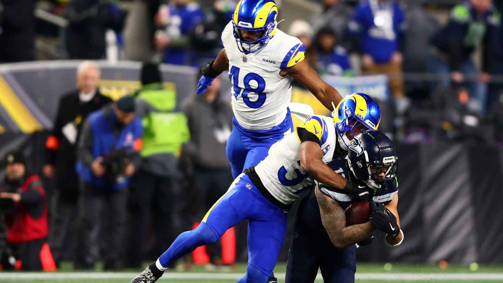 Seattle Seahawks wide receiver Jaxon Smith-Njigba (11) makes a catch against Los Angeles Rams safety Quentin Lake (37) during the second half in the 2026 NFC Championship Game at Lumen Field.
