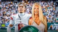 New York Giants rookie quarterback Jaxson Dart and Marissa Ayers with MetLife Stadium background.