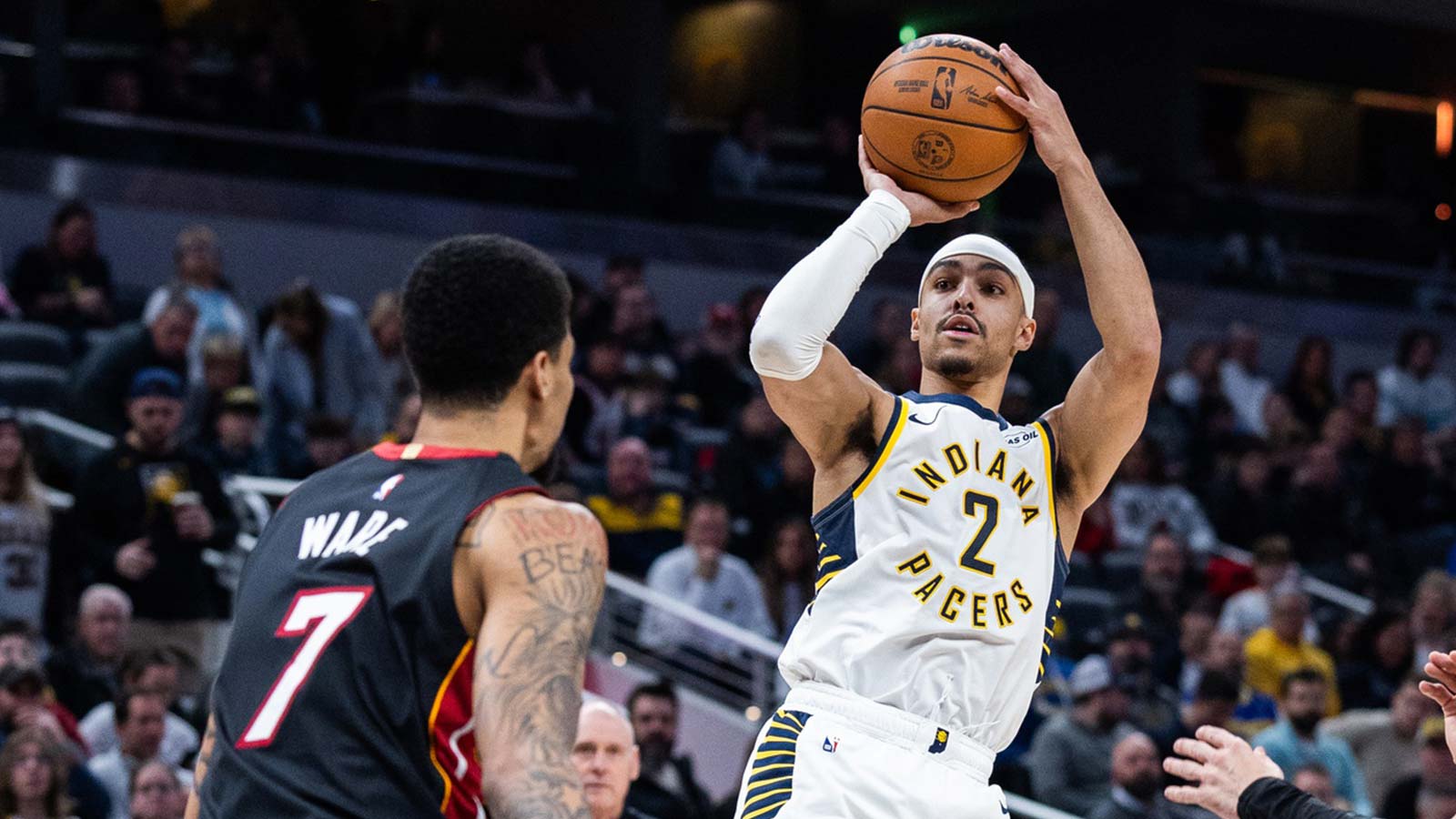 Indiana Pacers guard/forward Andrew Nembhard (2) shoots the ball while Miami Heat center Kel'el Ware (7) defends in the first half at Gainbridge Fieldhouse.