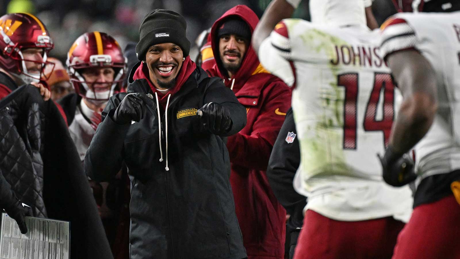 Washington Commanders quarterback Jayden Daniels (5) celebrates touchdown run by quarterback Josh Johnson (14) during the fourth quarter against the Philadelphia Eagles at Lincoln Financial Field.