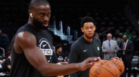 Boston Celtics guard Anfernee Simons (4) and guard/forward Jaylen Brown (7) warm up before the start of the game against the Washington Wizards at TD Garden.