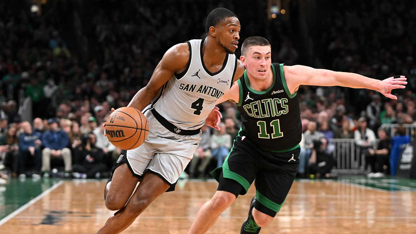 San Antonio Spurs guard De'aaron Fox (4) drives to the basket against Boston Celtics guard Payton Pritchard (11) during the first half at the TD Garden.