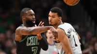 Boston Celtics guard Jaylen Brown (7) passes the ball against the San Antonio Spurs during the first half at the TD Garden.