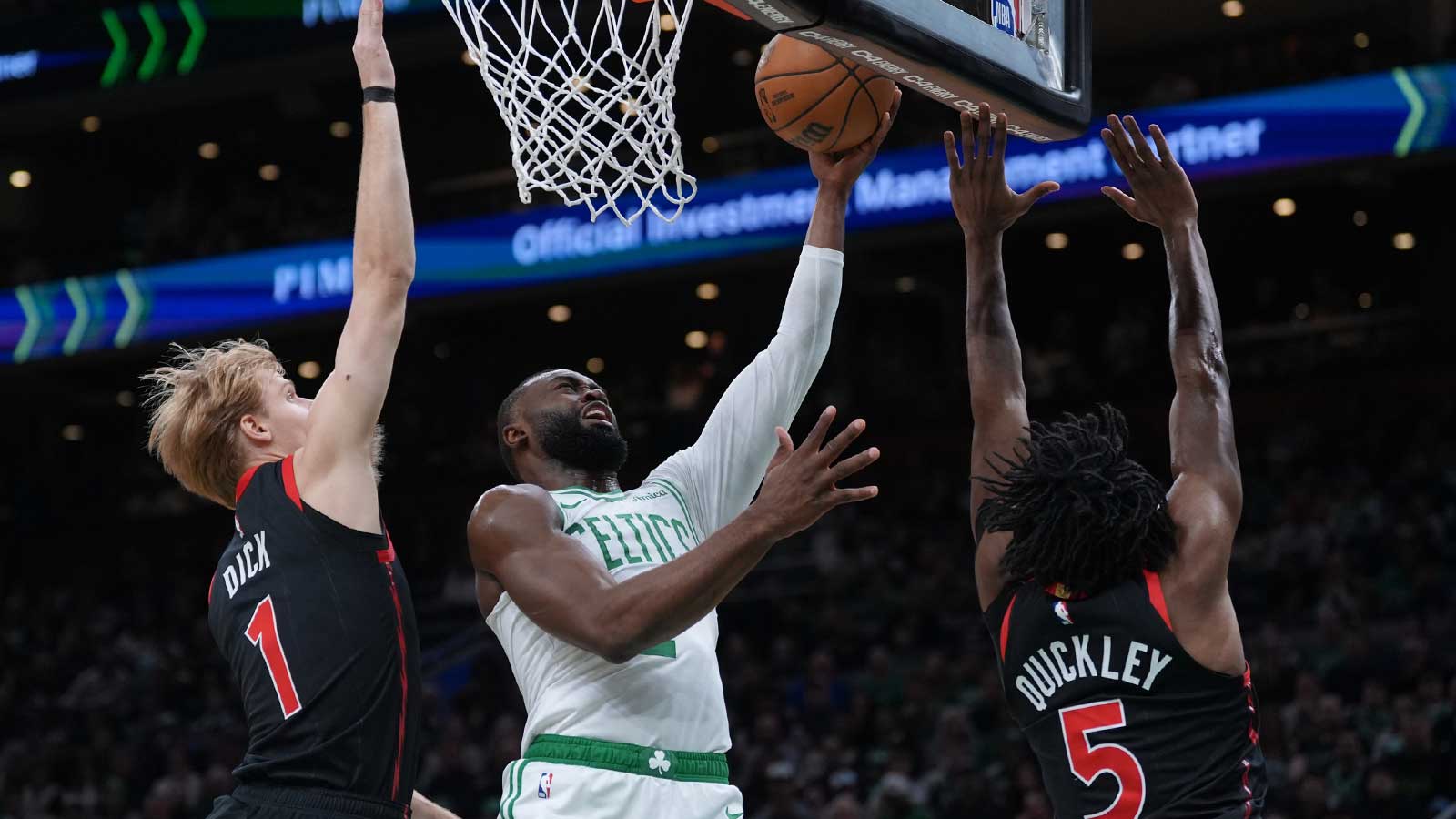 Boston Celtics guard Jaylen Brown (7) drives to the basket against Toronto Raptors guard Immanuel Quickley (5) and guard Gradey Dick (1) in the first quarter at TD Garden.