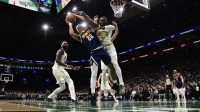Boston Celtics guard Jaylen Brown (7) fouls Denver Nuggets forward Zeke Nnaji (22) during the second half at TD Garden.